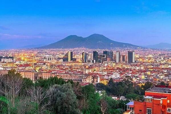 Naples, Italy with the financial district skyline under Mt. Vesuvius at twilight