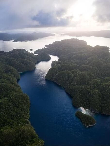 A narrow, coral-filled channel runs through islands in Raja Ampat, Indonesia. This tropical area is known for its incredibly high marine biodiversity