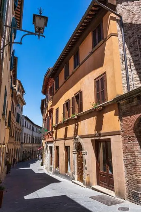 Framed Print : Narrow, winding street of Via di Voltaia nel Corso in Montepulciano, Tuscany, Italy Framed Print : Narrow, winding street of Via di Voltaia nel Corso in Montepulciano, Tuscany, Italy