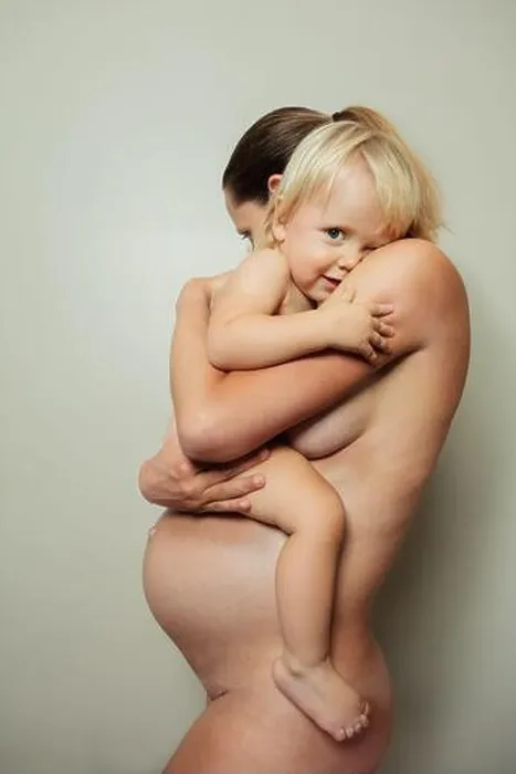 Framed Print : Natural beautiful photo of naked woman with toddler in hands Framed Print : Natural beautiful photo of naked woman with toddler in hands