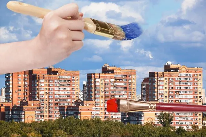 Framed Print : nature concept - hand with paintbrush paints blue clouds over modern urban buildings Framed Print : nature concept - hand with paintbrush paints blue clouds over modern urban buildings