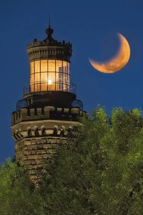 Framed Print : Navesink Twin Lights - Close view to one of the illuminated Lighthouse with the setting moon alongside Framed Print : Navesink Twin Lights - Close view to one of the illuminated Lighthouse with the setting moon alongside