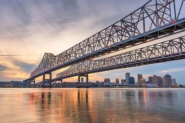 New Orleans, Louisiana, USA at Crescent City Connection Bridge over the Mississippi River at dusk