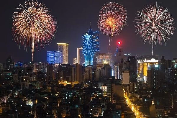 New Yearâ€™s fireworks at Macau (Macao), China. Skyscraper hotel and casino building at downtown in Macau (Macao)
