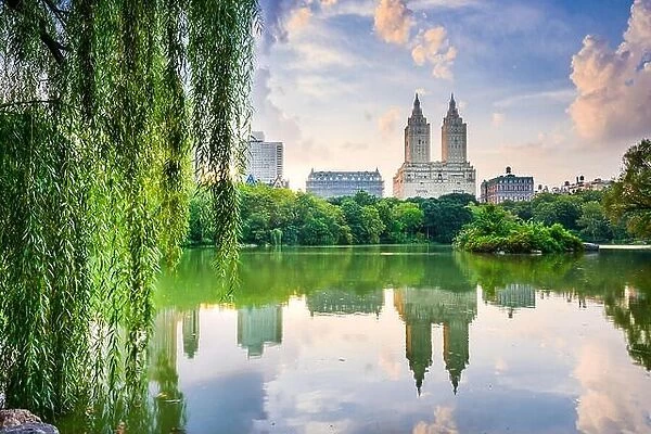 New York City, USA at the Central Park Lake and Upper West Side skyline