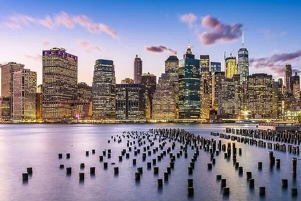 New York City, USA city skyline on the East River at dusk