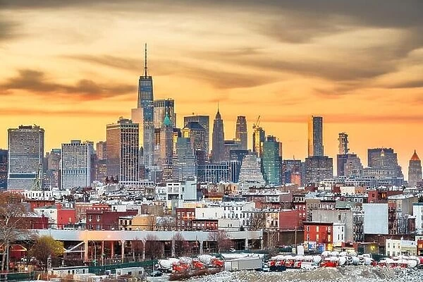 New York City, USA midtown Manhattan skyline at dusk with Brooklyn's industrial areas in the foreground
