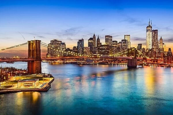 New York City, USA skyline over East River and Brooklyn Bridge