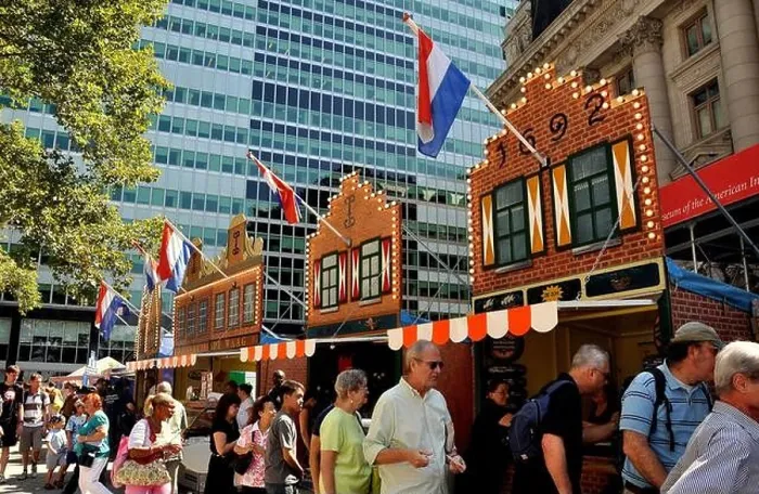 Framed Print : New York City: Visitors in front of gabled facades of 17th century Dutch buildings at the New Amsterdam Village Framed Print : New York City: Visitors in front of gabled facades of 17th century Dutch buildings at the New Amsterdam Village