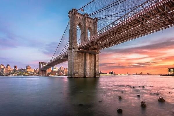 New York, New York, USA at the Brooklyn Bridge spanning the East River to Brooklyn at dusk