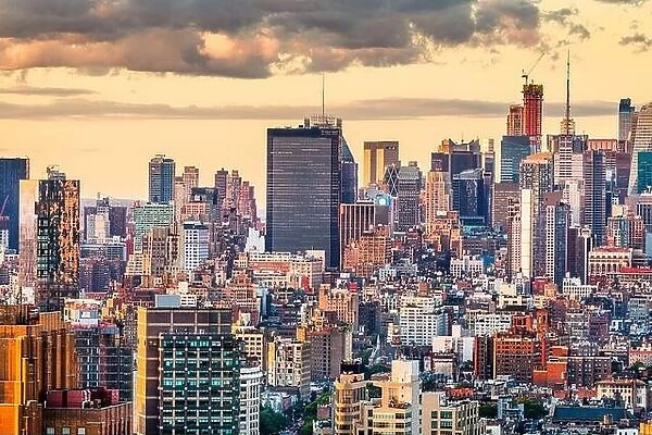 New York, New York, USA dense city skyline over Chelsea looking towards Hell's Kitchen at dusk