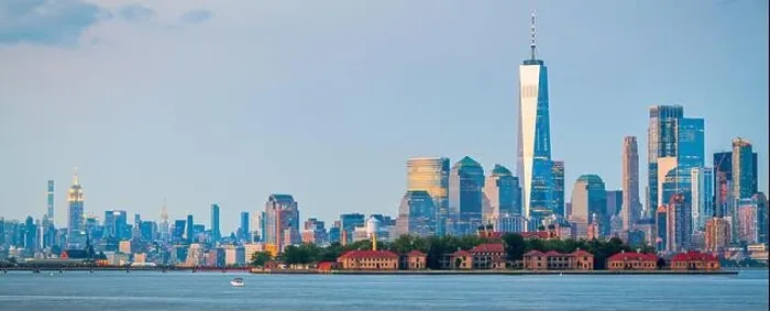 Framed Print : New York, New York, USA skyline from the harbor with Ellis Island at dusk Framed Print : New York, New York, USA skyline from the harbor with Ellis Island at dusk