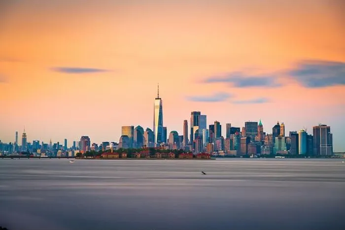 Framed Print : New York, New York, USA skyline from the harbor with Ellis Island at dusk Framed Print : New York, New York, USA skyline from the harbor with Ellis Island at dusk