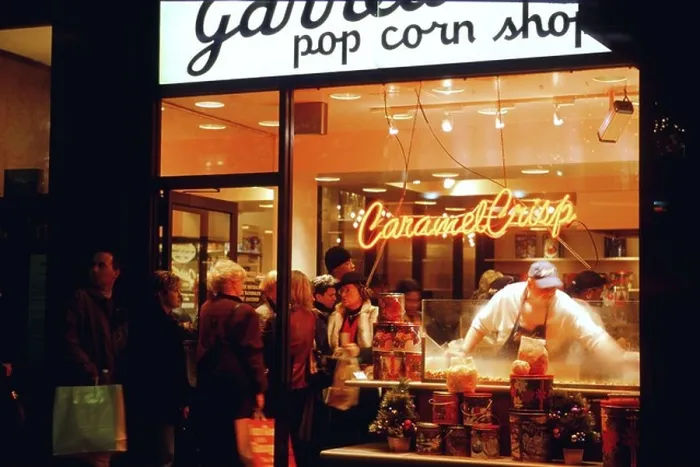 Framed Print : NIGHT Chicago Illinois Garretts popcorn shop on Michigan Avenue customers in line man scoop caramel corn