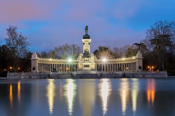 Night cityscape with lights at the memorial in Retiro city park, Madrid, Spain