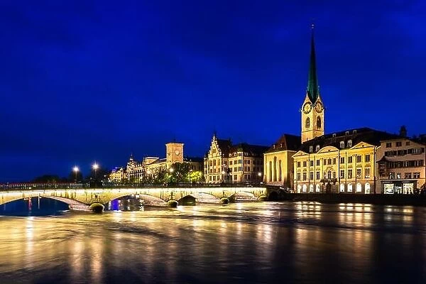Night view of historic Zurich city center with famous Fraumunster Church and river Limmat in Zurich, Switzerland