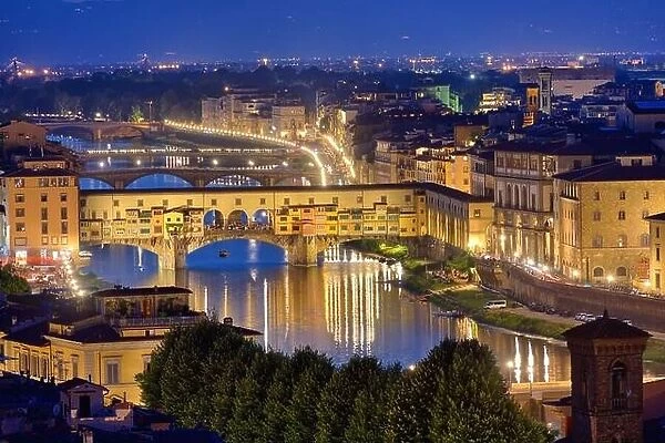 Night view of the River Arno and famous bridge Ponte Vecchio. Beautiful city night lights in Florence, Italy
