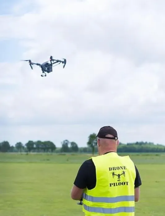 Framed Print : NIJVERDAL, NETHERLANDS - JUNE 23, 2018: Professional drone pilot controling a drone with camera Framed Print : NIJVERDAL, NETHERLANDS - JUNE 23, 2018: Professional drone pilot controling a drone with camera