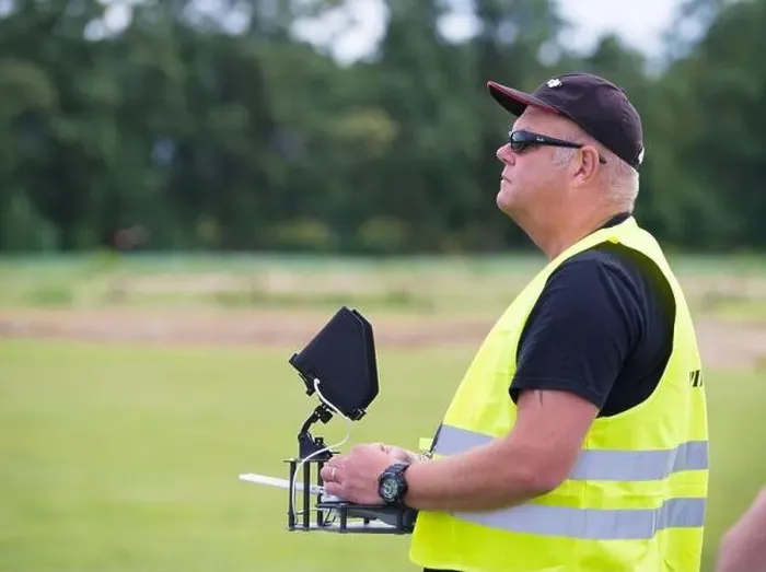 Framed Print : NIJVERDAL, NETHERLANDS - JUNE 23, 2018: Professional drone pilot controling a drone with camera Framed Print : NIJVERDAL, NETHERLANDS - JUNE 23, 2018: Professional drone pilot controling a drone with camera