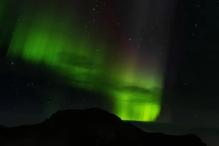 Framed Print : Northern lights above a montaga in the city of Vik, Iceland Framed Print : Northern lights above a montaga in the city of Vik, Iceland