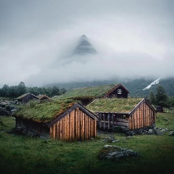 Norwegian old wooden fishing houses with grass roofs in Innerdalen - Norway's most beautiful mountains valley, near Innerdalsvatna lake