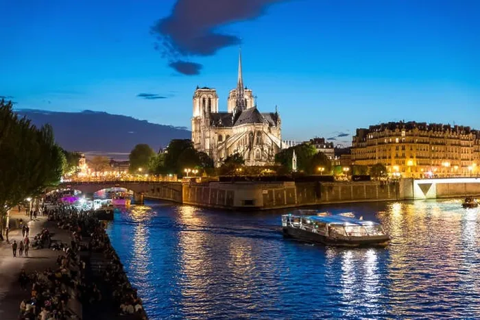 Framed Print : Notre Dame de Paris with cruise ship on Seine river at night in Paris, France Framed Print : Notre Dame de Paris with cruise ship on Seine river at night in Paris, France
