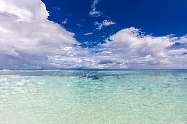 Ocean seascape. Ocean waves with blue sky and clouds, relaxing tropical sea lagoon. Blue sky with light clouds, turquoise ocean with surf, ecology