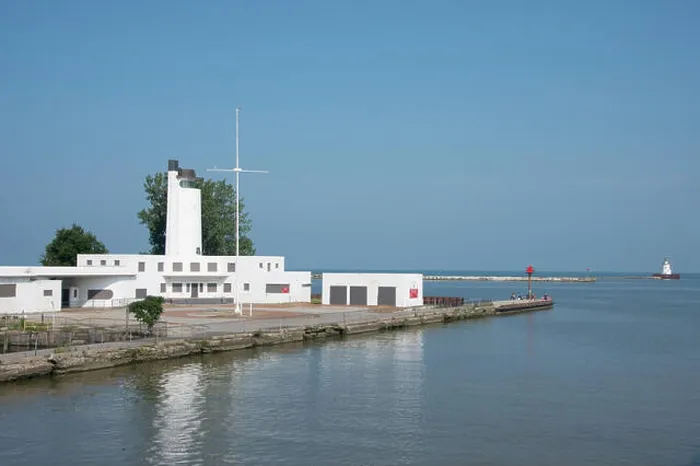 Framed Print : Ohio, Lake Erie, Cleveland. Cleveland Harbor, historic Coast Guard Station and Boat House, people fishing off the pier Framed Print : Ohio, Lake Erie, Cleveland. Cleveland Harbor, historic Coast Guard Station and Boat House, people fishing off the pier