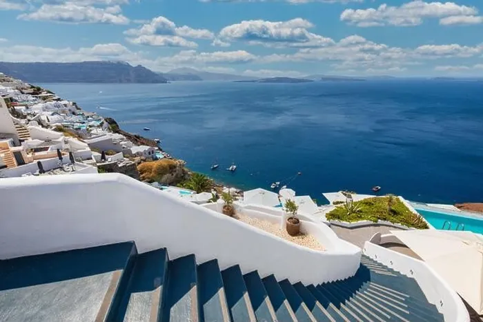 Framed Print : Oia town on Santorini island, Greece. Traditional famous white blue houses stairs, pathways under sunny blue sky Caldera, Aegean sea. Beautiful summer