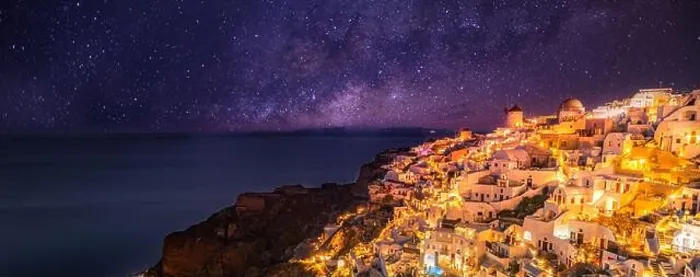 Framed Print : Oia village at night, Santorini island. Famous travel landscape, luxury vacation destination scenic. Beautiful view of fabulous picturesque village