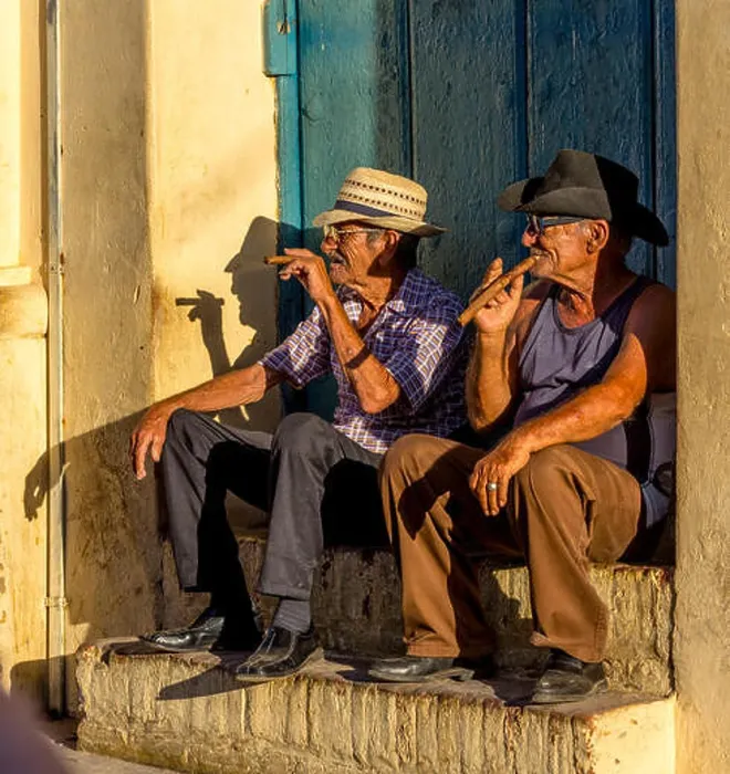 Framed Print : Two old Cubans smoke cigars and sit on a staircase in the warm light of the sunset Framed Print : Two old Cubans smoke cigars and sit on a staircase in the warm light of the sunset