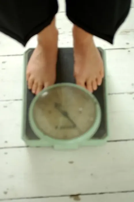 Framed Print : Old Fashioned Weighing scales and feet defocused Framed Print : Old Fashioned Weighing scales and feet defocused