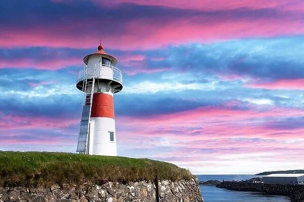 Old lighthouse outside Torshavn city against incredible purple sunset sky, Streymoy island, Faroe Islands, Denmark