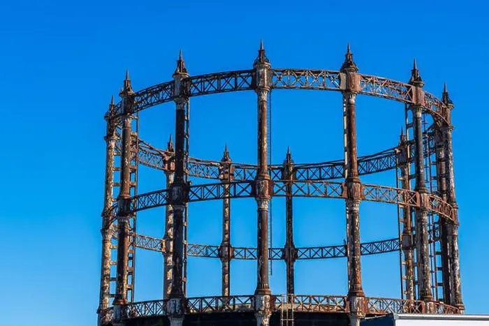 Framed Print : Old retro rusty Gas Holder or Gas tower against a blue sky in Great Yarmouth, Norfolk, UK
