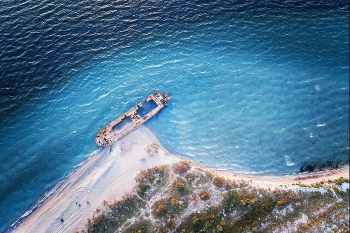 Framed Print : Old shipwreck reinforced concrete barge abandoned stand on beach on the coast of Black sea in Ukraine Framed Print : Old shipwreck reinforced concrete barge abandoned stand on beach on the coast of Black sea in Ukraine
