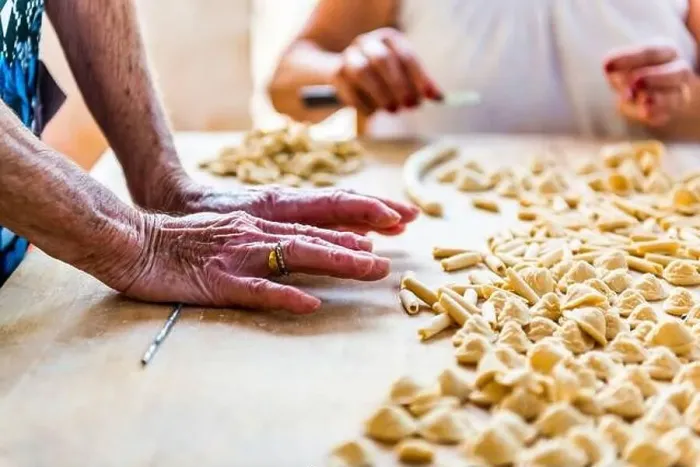Framed Print : An old woman, while prepare by hands Orecchiette, typical italian pasta