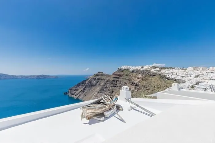 Framed Print : Old wooden boat on the white rooftops of caldera in Santorini, Greece. Amazing summer landscape, travel adventure, sea view over white architecture Framed Print : Old wooden boat on the white rooftops of caldera in Santorini, Greece. Amazing summer landscape, travel adventure, sea view over white architecture