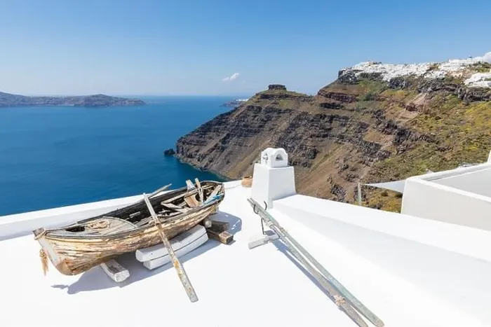Framed Print : Old wooden boat on the white rooftops of caldera in Santorini, Greece. Amazing summer landscape, travel adventure, sea view over white architecture Framed Print : Old wooden boat on the white rooftops of caldera in Santorini, Greece. Amazing summer landscape, travel adventure, sea view over white architecture
