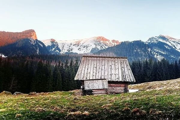 Old wooden hut and sunset sky in spring High Tatras mountains in Kalatowki meadow, Zakopane, Poland. Landscape photography