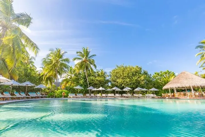 Framed Print : Outdoor summer tourism landscape. Luxurious beach resort with swimming pool and beach chairs or loungers under umbrellas with palm trees and blue sky Framed Print : Outdoor summer tourism landscape. Luxurious beach resort with swimming pool and beach chairs or loungers under umbrellas with palm trees and blue sky