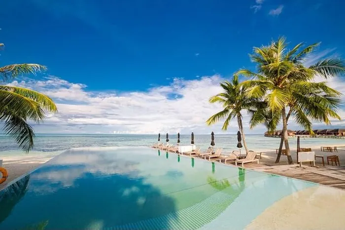 Framed Print : Outdoor tourism landscape. Luxurious beach resort with swimming pool and beach chairs or loungers under umbrellas with palm trees and blue sky. Summer Framed Print : Outdoor tourism landscape. Luxurious beach resort with swimming pool and beach chairs or loungers under umbrellas with palm trees and blue sky. Summer