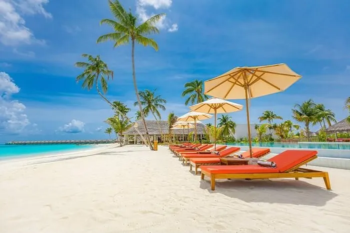 Framed Print : Outdoor tourism landscape. Luxurious beach resort with swimming pool and beach chairs or loungers under umbrellas with palm trees and blue sky. Summer Framed Print : Outdoor tourism landscape. Luxurious beach resort with swimming pool and beach chairs or loungers under umbrellas with palm trees and blue sky. Summer
