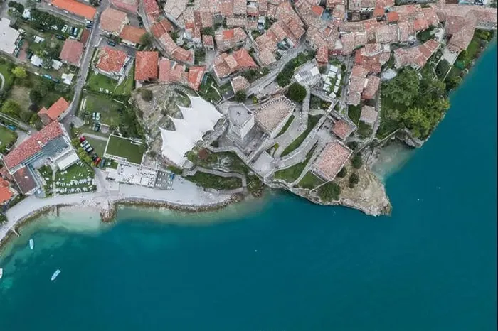Framed Print : Overhead aerial drone shot view of village Malcesine coastline by lake garda Framed Print : Overhead aerial drone shot view of village Malcesine coastline by lake garda