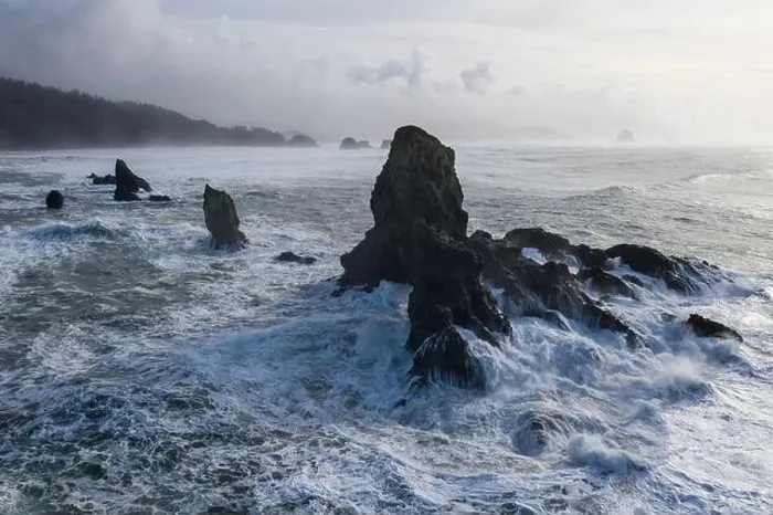 Framed Print : The Pacific Ocean crashes against rocks off the coast of northern Oregon. This wild region, just west of Portland, is often covered by a dark clouds Framed Print : The Pacific Ocean crashes against rocks off the coast of northern Oregon. This wild region, just west of Portland, is often covered by a dark clouds