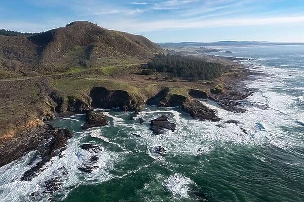 The Pacific Ocean meets the beautiful and rocky shoreline of Northern California. The Pacific Coast Highway runs along this scenic coast