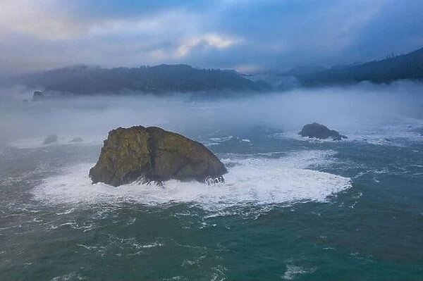 The Pacific Ocean washes against rugged sea stacks found just off the scenic coast of Northern California in Klamath