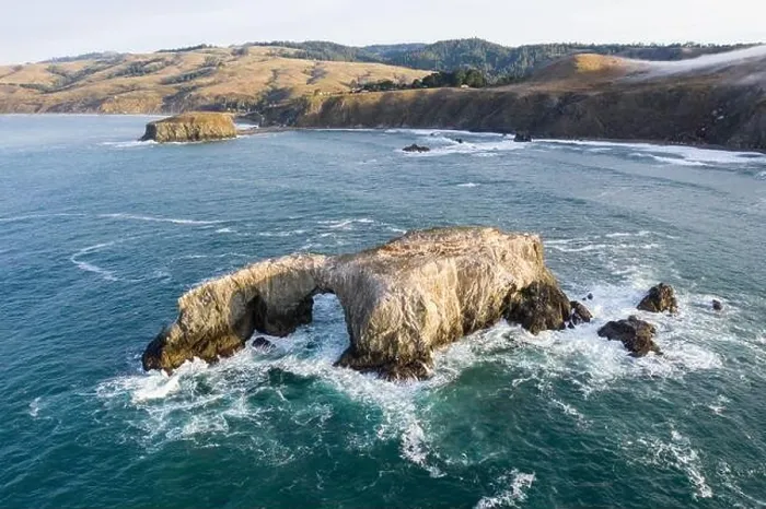 Framed Print : The Pacific Ocean washes against a sea stack off the northern California Sonoma coast. This region is often covered by a thick marine layer of mist Framed Print : The Pacific Ocean washes against a sea stack off the northern California Sonoma coast. This region is often covered by a thick marine layer of mist