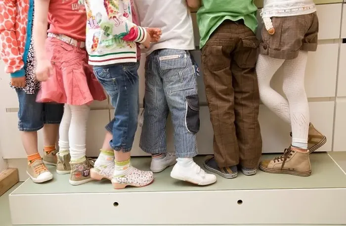 Framed Print : Six pair of girls and boys legs Framed Print : Six pair of girls and boys legs