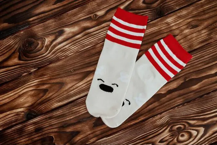 Framed Print : A pair of socks featuring a polar bear design are displayed against a white background Framed Print : A pair of socks featuring a polar bear design are displayed against a white background