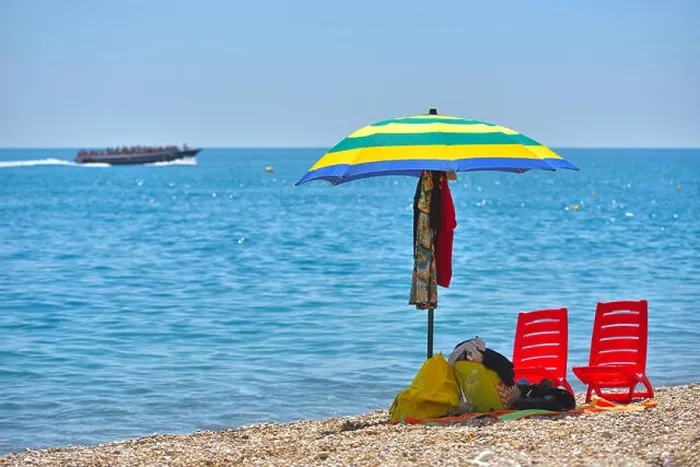 Framed Print : Pair of sun loungers and a beach umbrella on a deserted beach; perfect vacation concept Framed Print : Pair of sun loungers and a beach umbrella on a deserted beach; perfect vacation concept